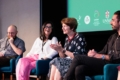 Panel discussion with four people seated, engaged in conversation.